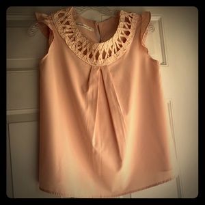 Pale pink sleeveless top w/ round cross-cross neck